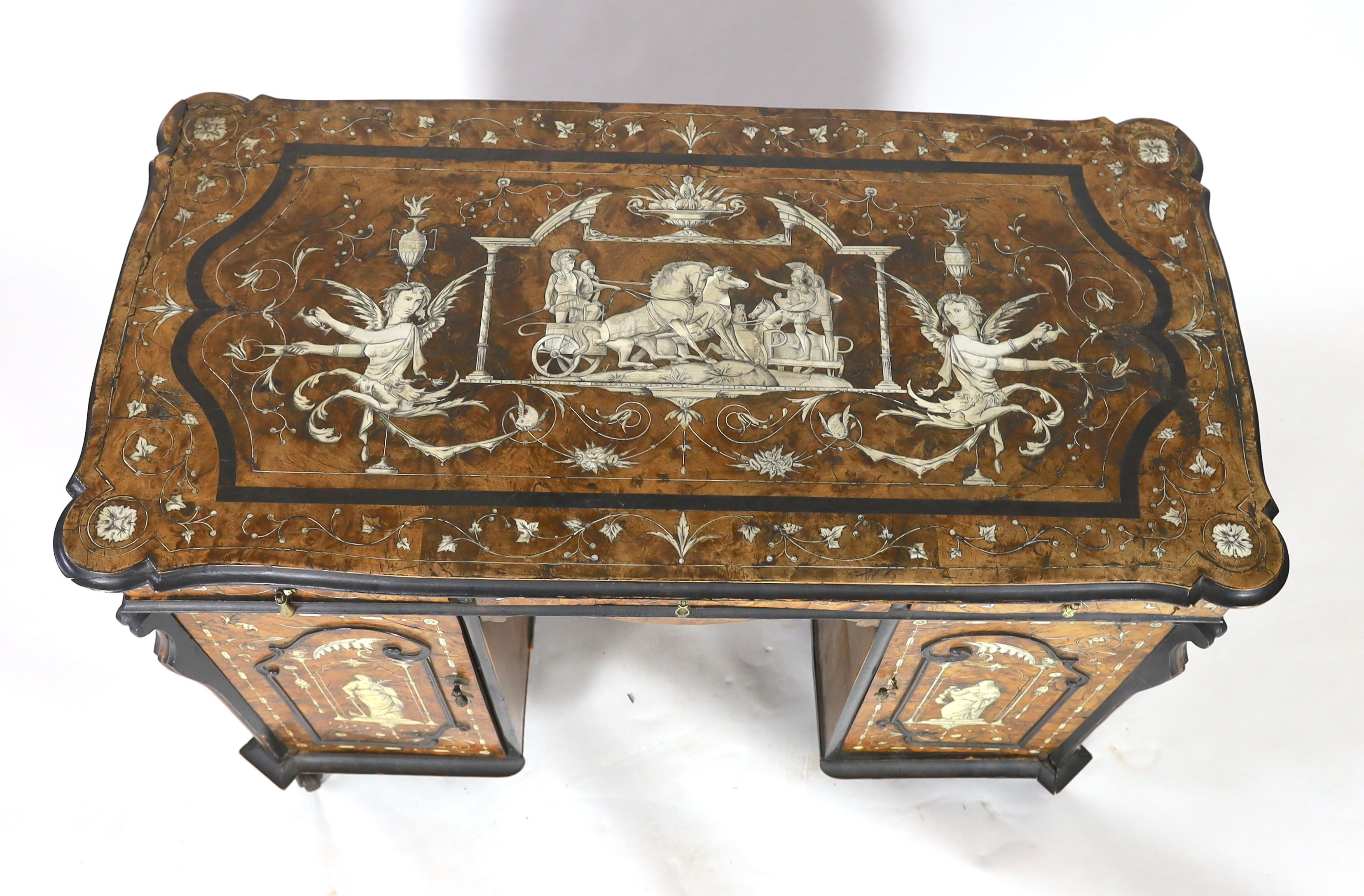 An important 18th century Lombardy ebony banded walnut and ivory inlaid twin pedestal desk, the top and sides inlaid with a scenes from Homer’s Iliad, after original drawings by John Flaxman RA (1755-1826), width 118cm d